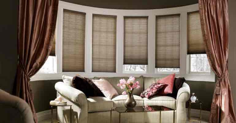 Brown cellular shades in lounge bow window.